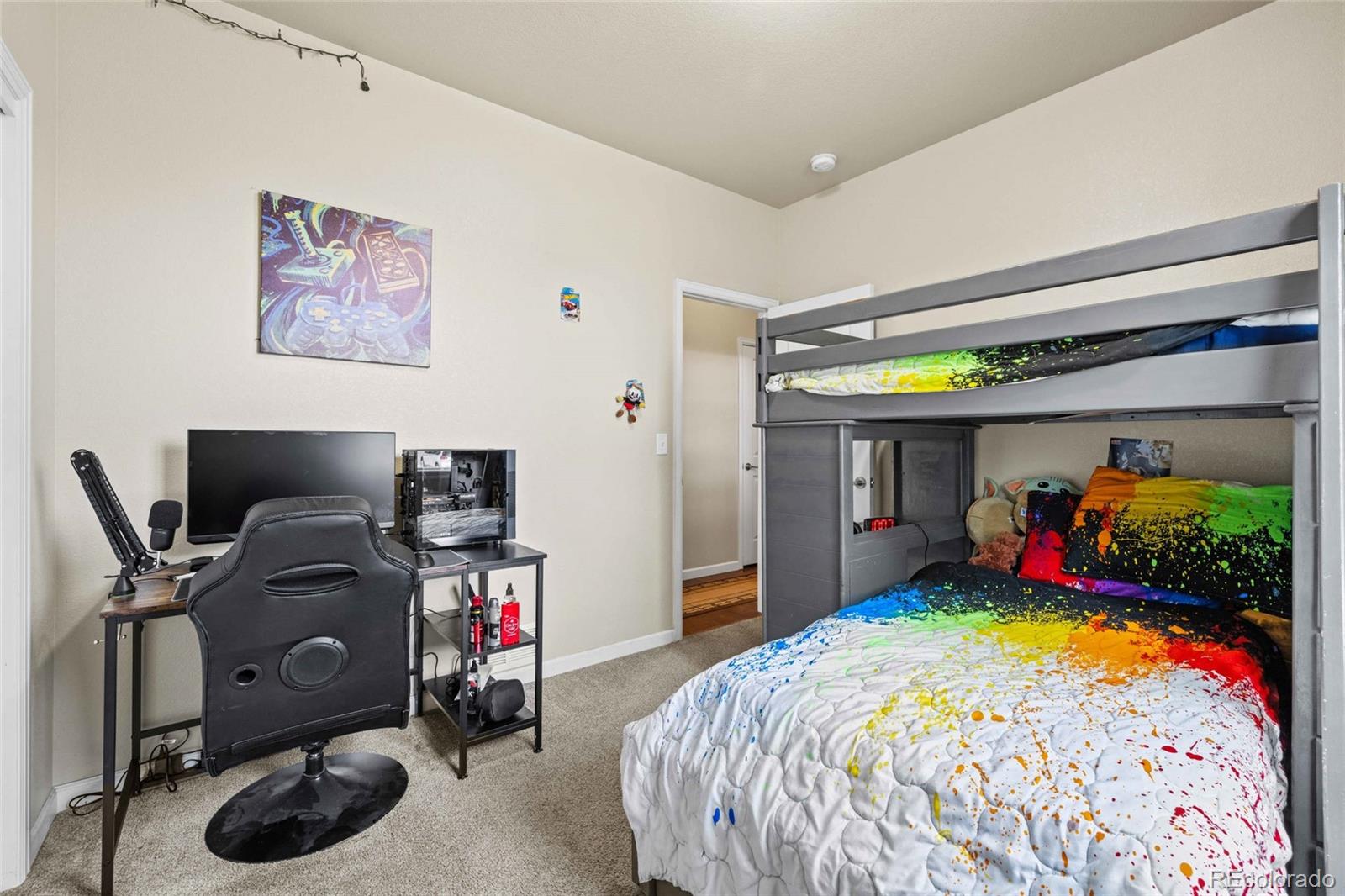 1030 Wagon Train Drive Milliken, CO 80543 - Photo 25 of 49 a bed room with a bed and a desk