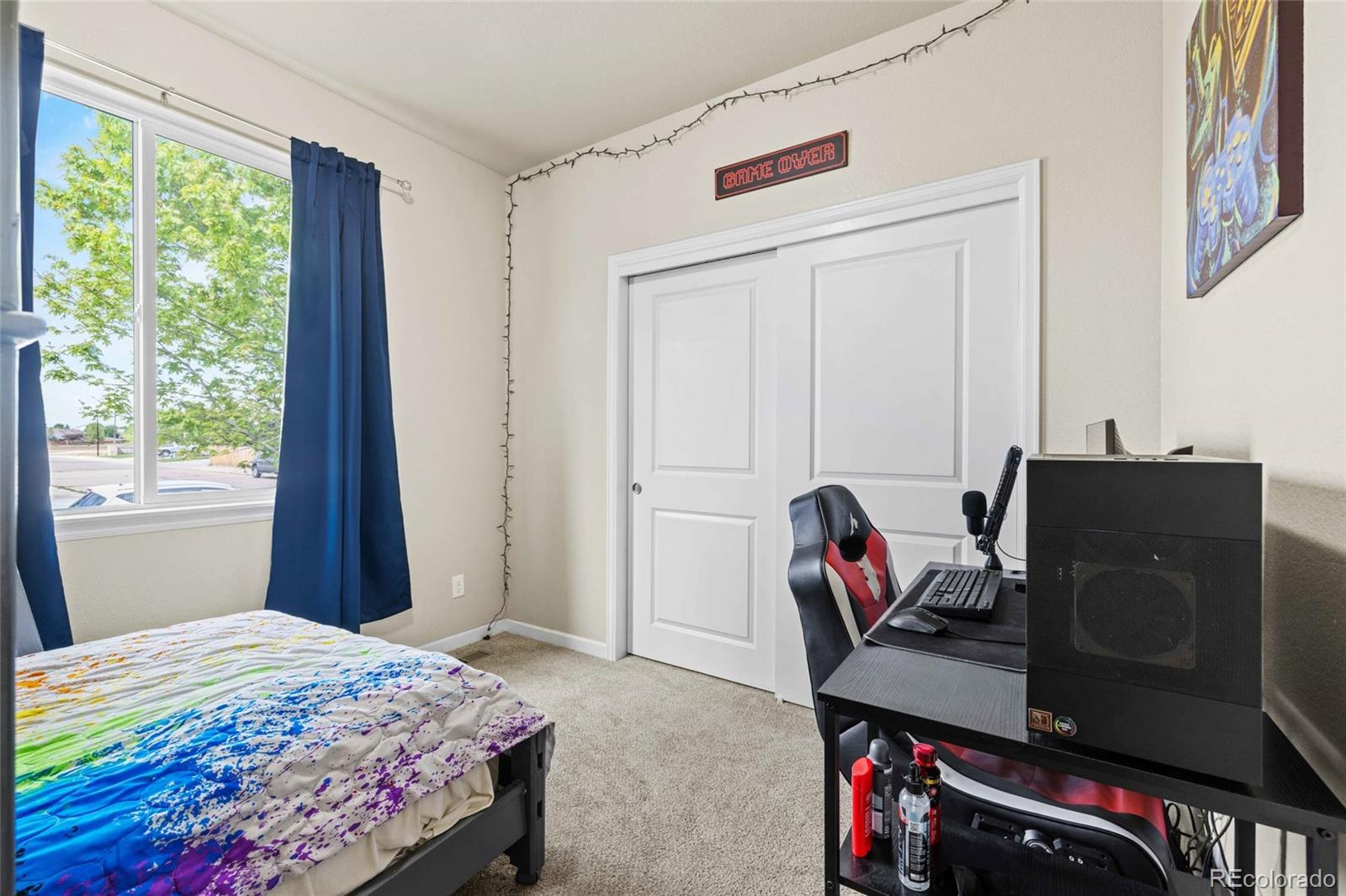 1030 Wagon Train Drive Milliken, CO 80543 - Photo 26 of 49 a bedroom with a bed and a window