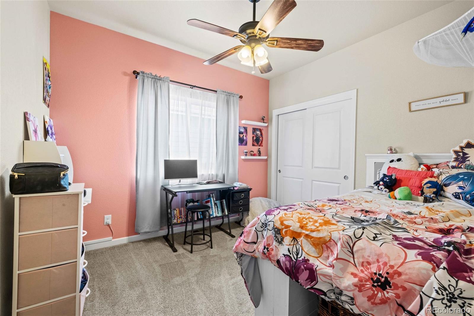 1030 Wagon Train Drive Milliken, CO 80543 - Photo 28 of 49 a bedroom with a bed and a table in it