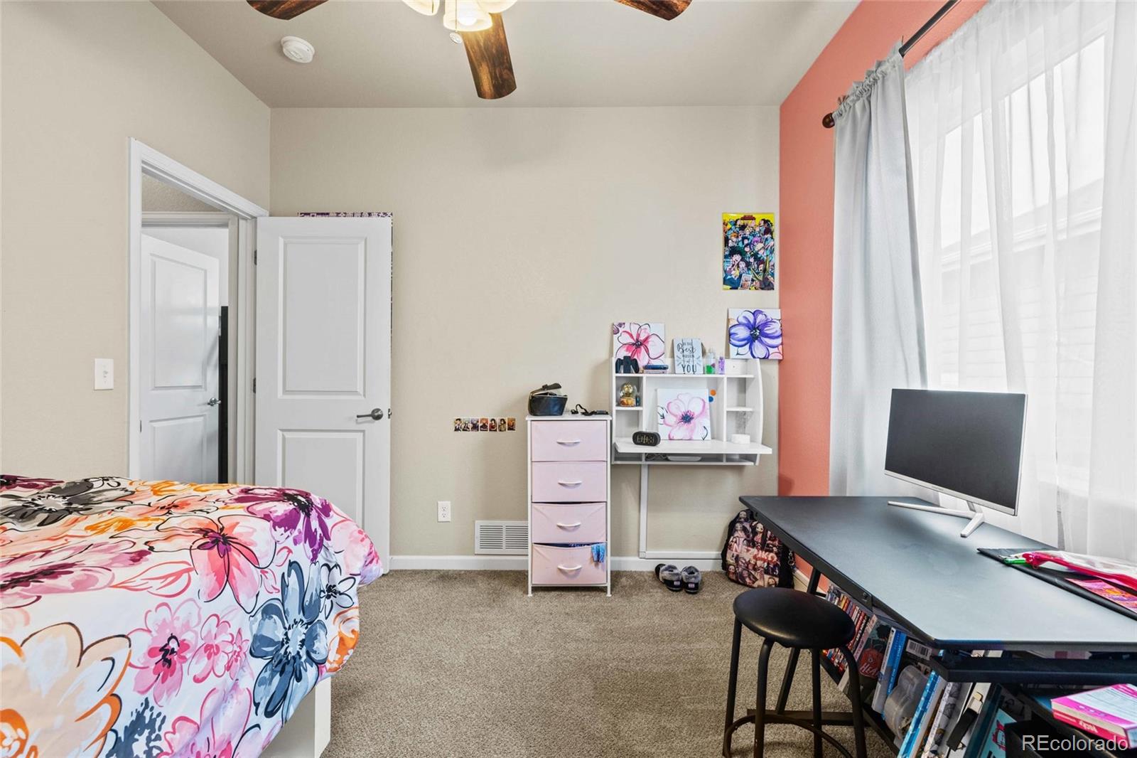 1030 Wagon Train Drive Milliken, CO 80543 - Photo 29 of 49 a bedroom with a bed and a desk