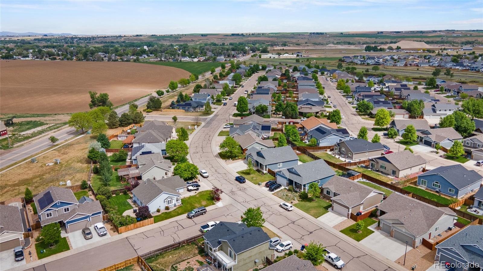1030 Wagon Train Drive Milliken, CO 80543 - Photo 47 of 49 an aerial view of a city with lots of residential buildings and ocean view in back