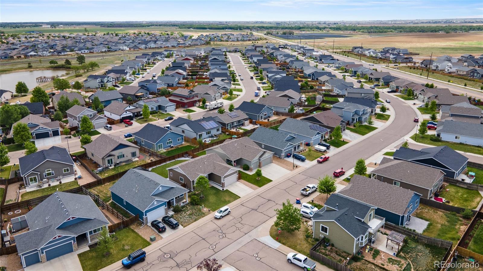 1030 Wagon Train Drive Milliken, CO 80543 - Photo 49 of 49 an aerial view of a city with a lake