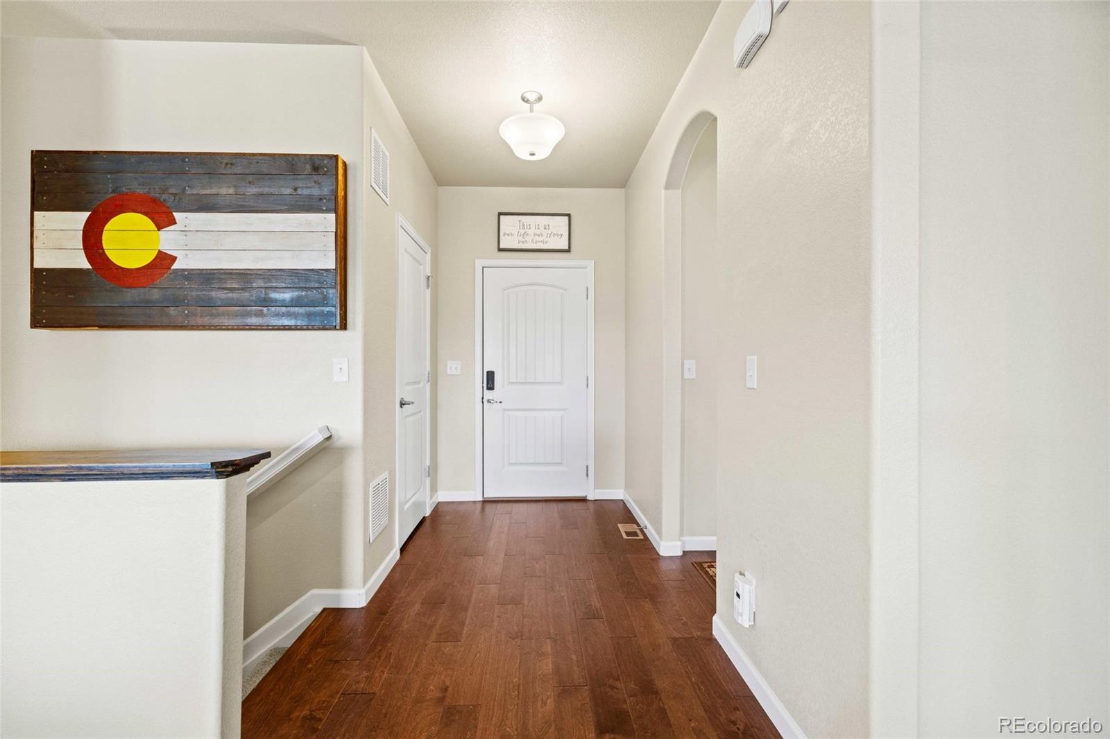 1030 Wagon Train Drive Milliken, CO 80543 - Photo 8 of 49 a view of a bathroom with a sink and wooden floor