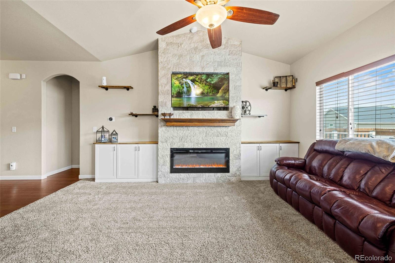 1030 Wagon Train Drive Milliken, CO 80543 - Photo 10 of 49 a living room with furniture and a fireplace
