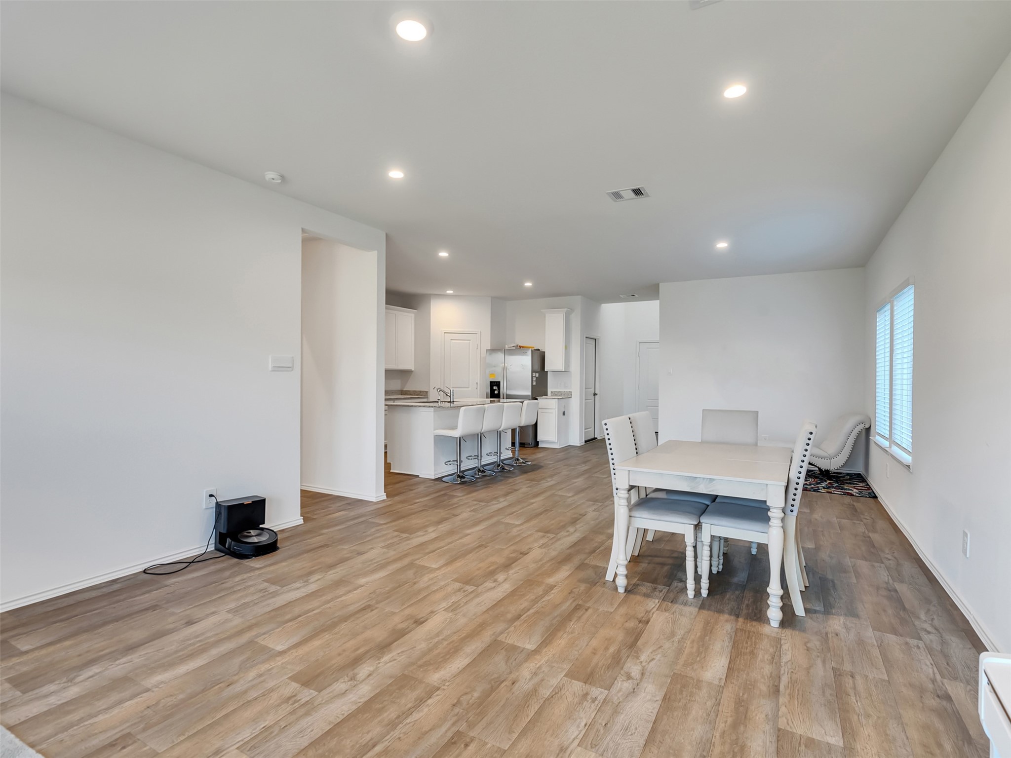 30903 Brightwell Bend Fulshear, TX 77441 - Photo 12 of 44 a dining room with furniture and a wooden floor