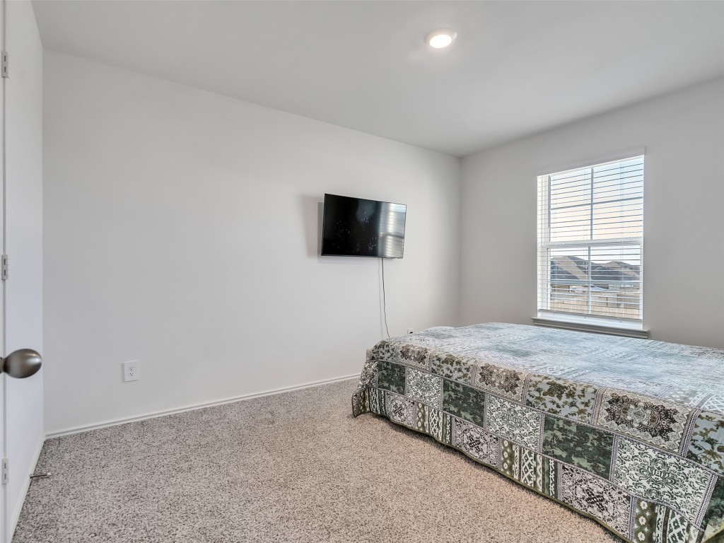 30903 Brightwell Bend Fulshear, TX 77441 - Photo 29 of 44 a bedroom with a bed and a flat screen tv