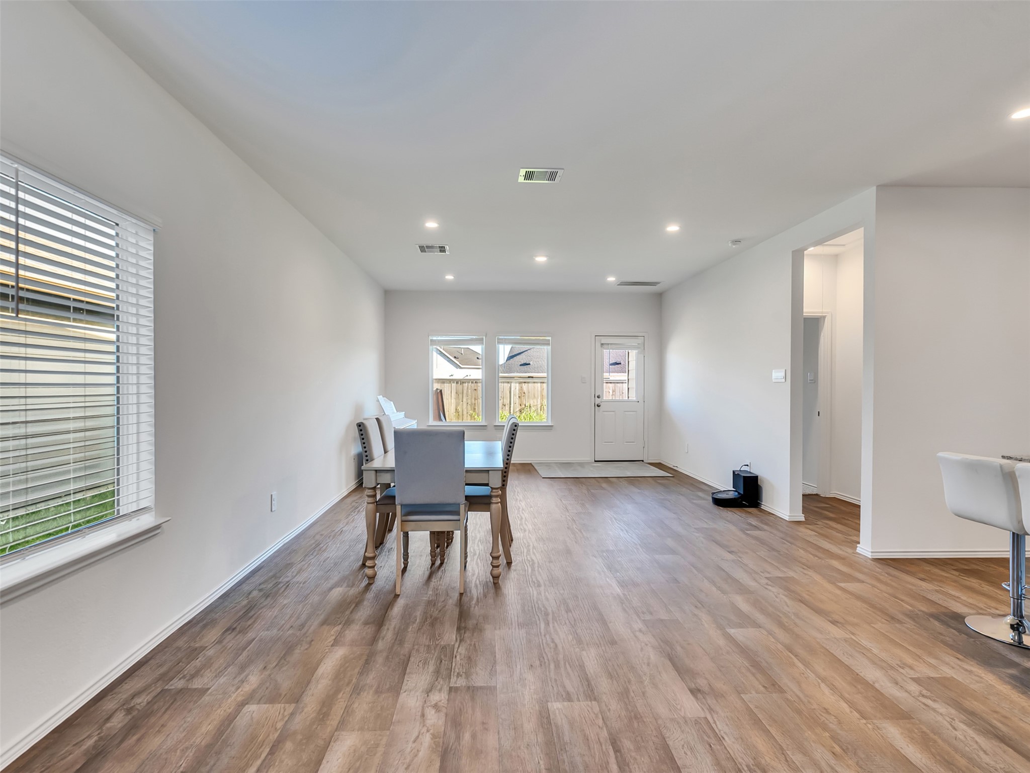 30903 Brightwell Bend Fulshear, TX 77441 - Photo 6 of 44 a view of a dining room with furniture and wooden floor
