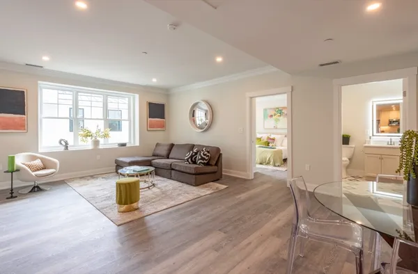 a living room with furniture and wooden floor