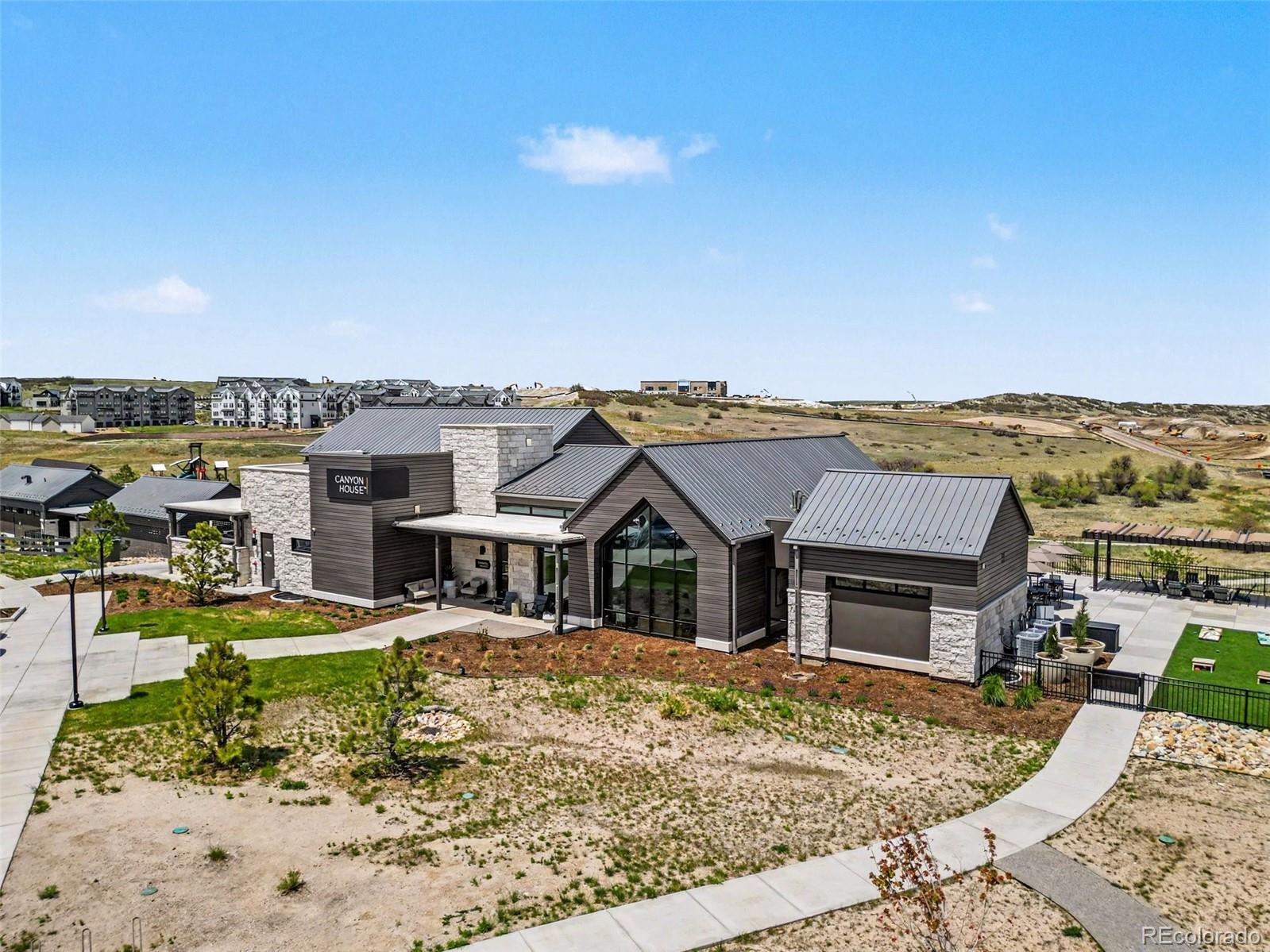2101 Rim Ridge Drive Castle Pines, CO 80108 - Photo 44 of 50 a view of a house with pool and ocean view
