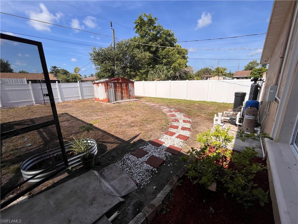 5000 17th Avenue Southwest Naples, FL 34116 - Photo 11 of 20 View of yard featuring a patio and a storage unit