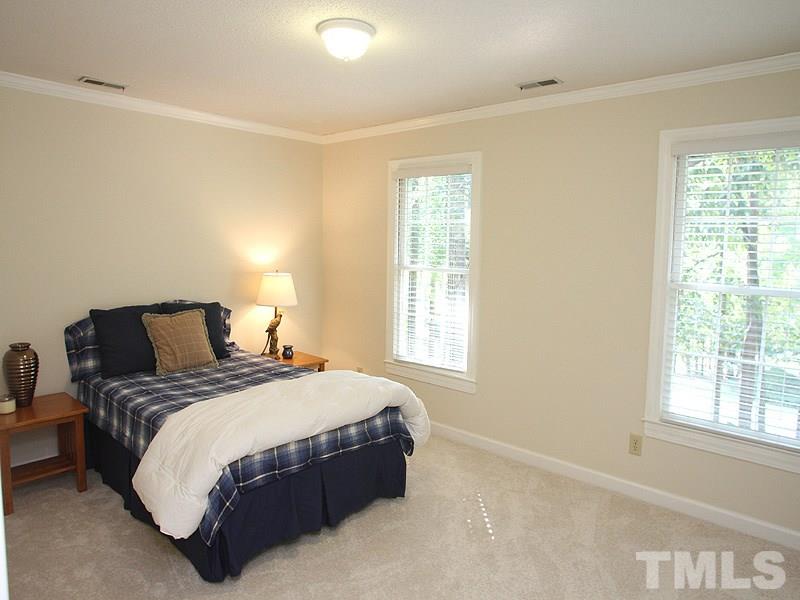 9905 Waterview Road Raleigh, NC 27615 - Photo 13 of 21 a large bed sitting in a bedroom next to a window