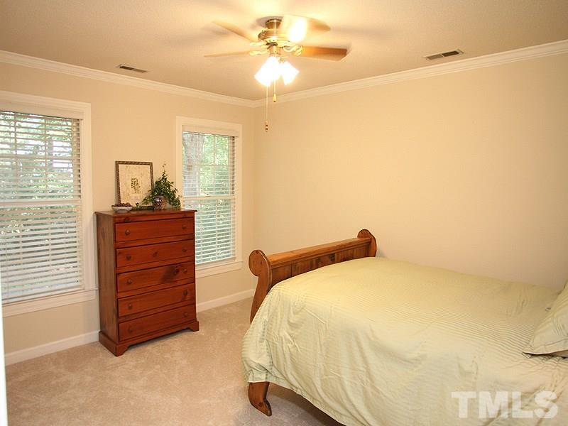 9905 Waterview Road Raleigh, NC 27615 - Photo 14 of 21 a bedroom with a bed and a dresser