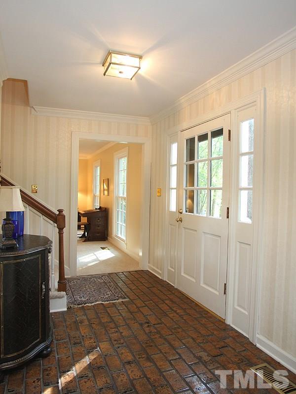 9905 Waterview Road Raleigh, NC 27615 - Photo 3 of 21 a view of a livingroom with wooden floor and a flat screen tv