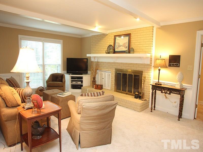 9905 Waterview Road Raleigh, NC 27615 - Photo 5 of 21 a living room with furniture a fireplace and a flat screen tv