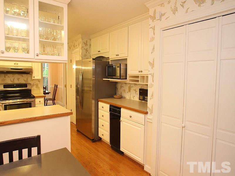 9905 Waterview Road Raleigh, NC 27615 - Photo 6 of 21 a kitchen with stainless steel appliances a refrigerator sink and stove