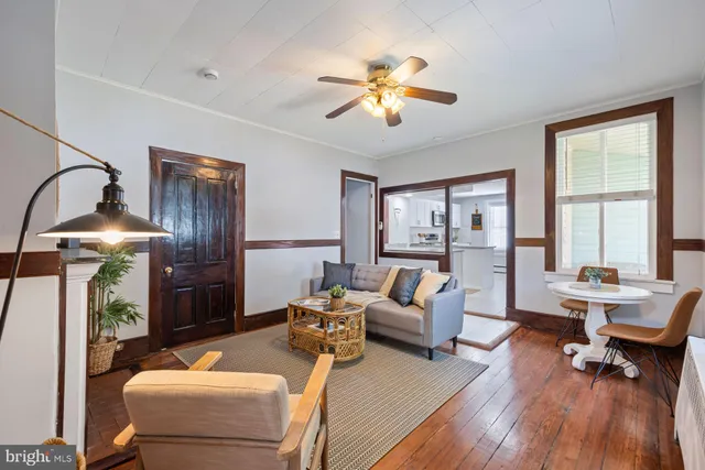 a living room with furniture and floor to ceiling windows