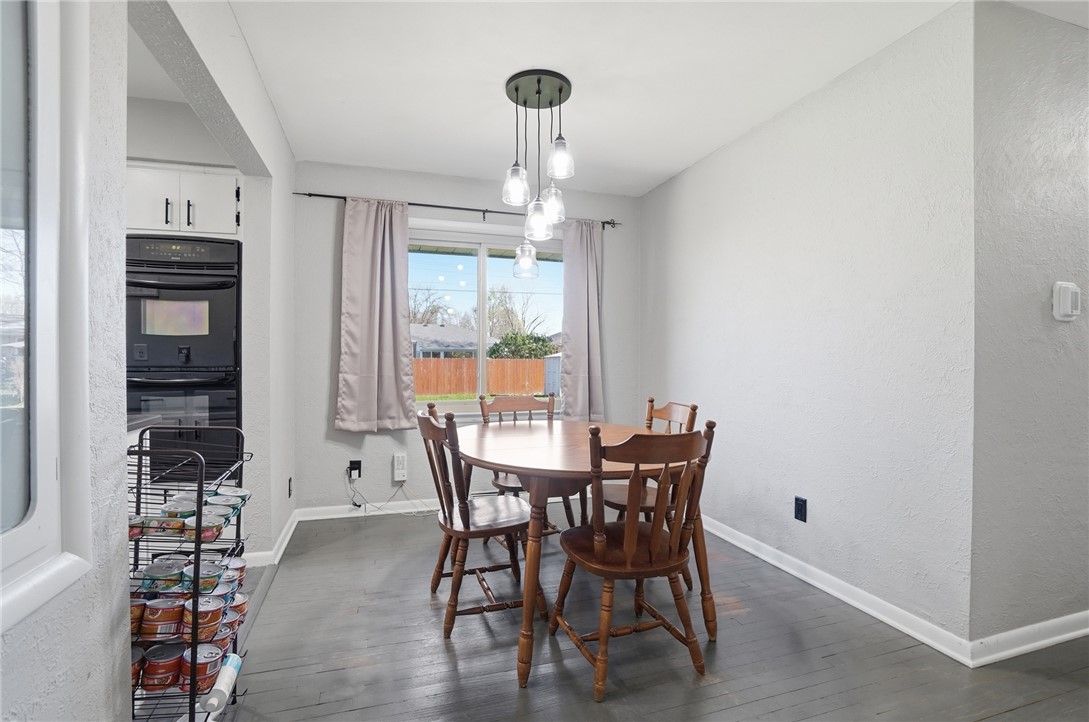 1325 Chelsea Road Troy, OH 45373 - Photo 13 of 42 This bright dining area features an elegant chandelier and a double oven, creating a functional space.
