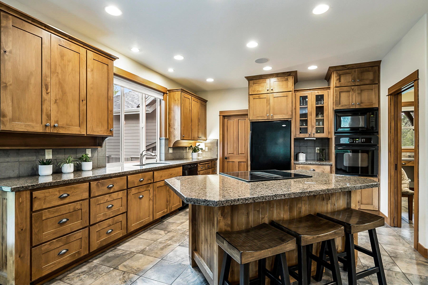 60819 Currant Way Bend, OR 97702 - Photo 14 of 44 Solid surfaces, ample cabinetry, and walk-in pantry.