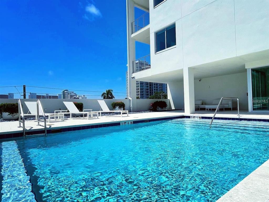 332 Cocoanut Avenue, Unit 505 Sarasota, FL 34236 - Photo 3 of 10 a swimming pool with outdoor seating and yard