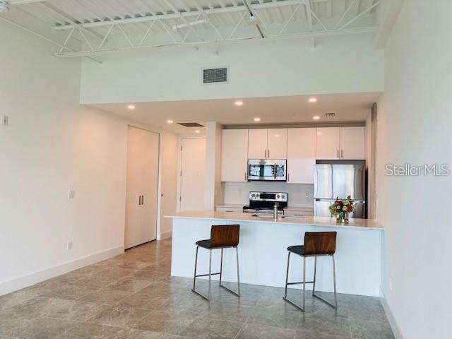 332 Cocoanut Avenue, Unit 505 Sarasota, FL 34236 - Photo 9 of 10 a kitchen with a sink a counter top space and appliances