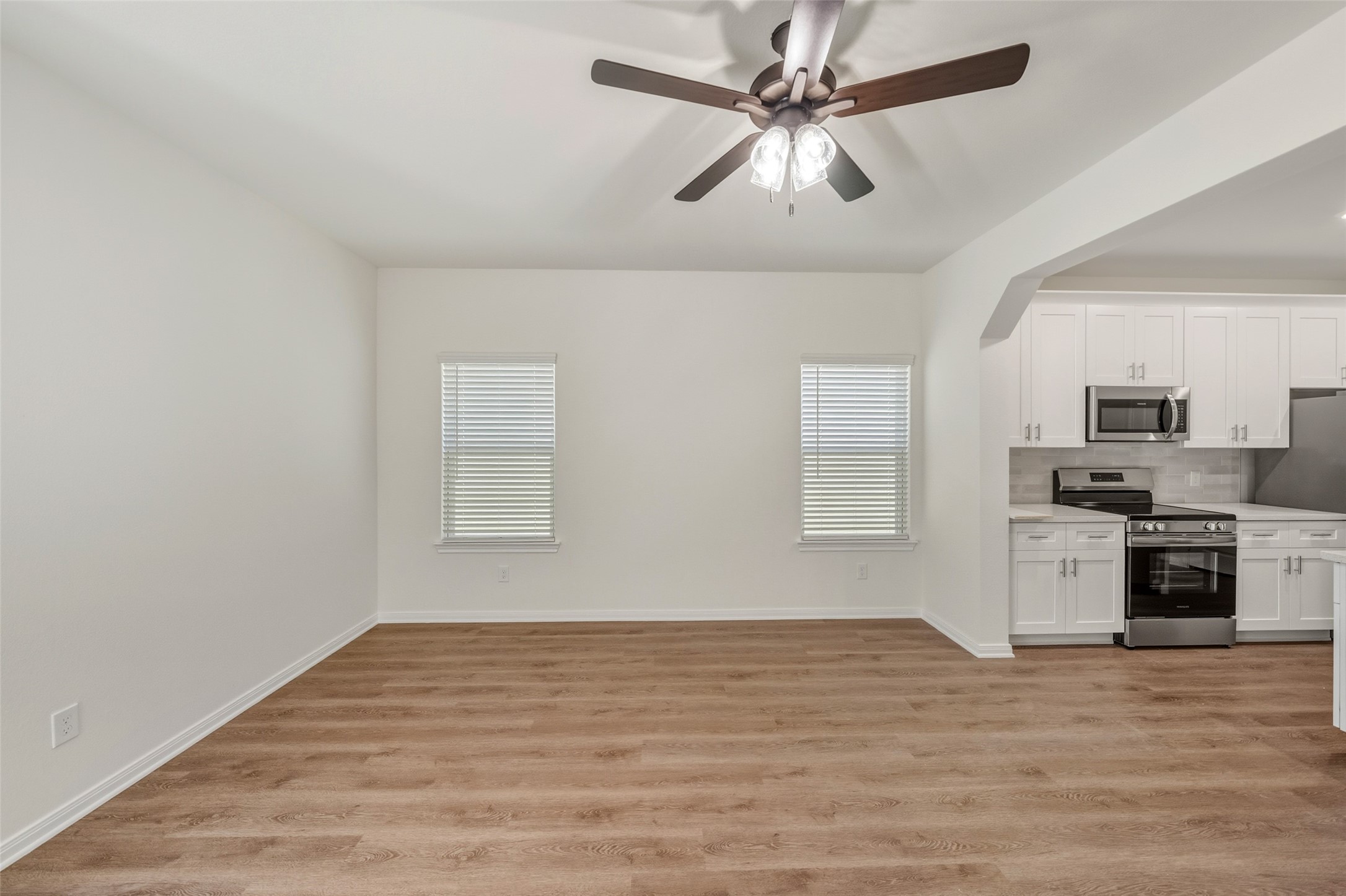 714 West Dallas Street Conroe, TX 77301 - Photo 4 of 19 a view of a kitchen with a dishwasher cabinets and wooden floor