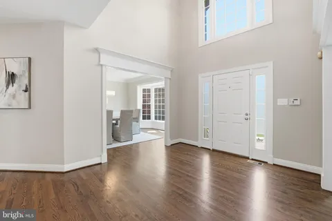 a living room with furniture a fireplace and a large window