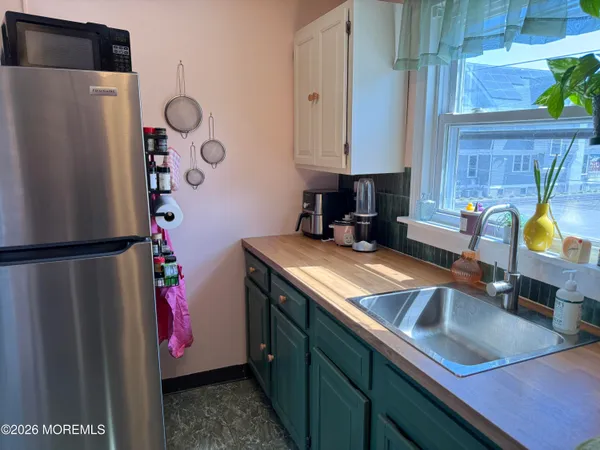 a kitchen with a refrigerator and a sink