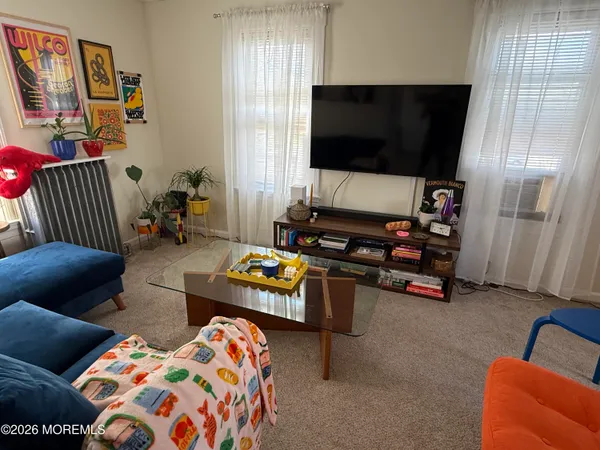 a bedroom with furniture and a flat screen tv
