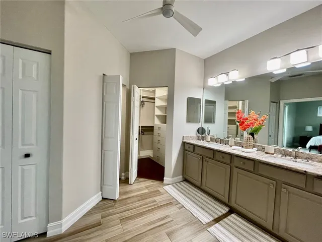 a kitchen with granite countertop a refrigerator a stove a microwave cabinets and a dining table