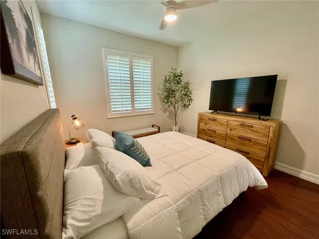a view of a patio with table and chairs potted plants and large tree