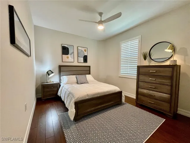 a view of a swimming pool with a lawn chairs and palm tree