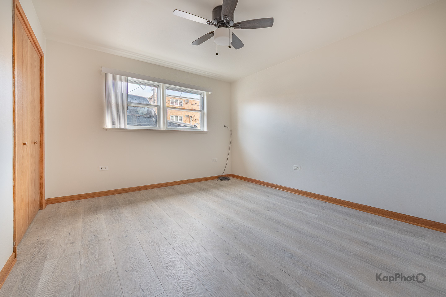 6914 West 65th Street, Unit 7 Chicago, IL 60638 - Photo 21 of 28 an empty room with wooden floor ceiling fan and windows
