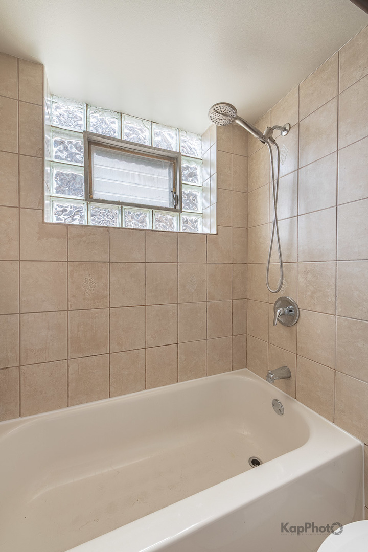 6914 West 65th Street, Unit 7 Chicago, IL 60638 - Photo 25 of 28 a bathroom with a bath tub and shower