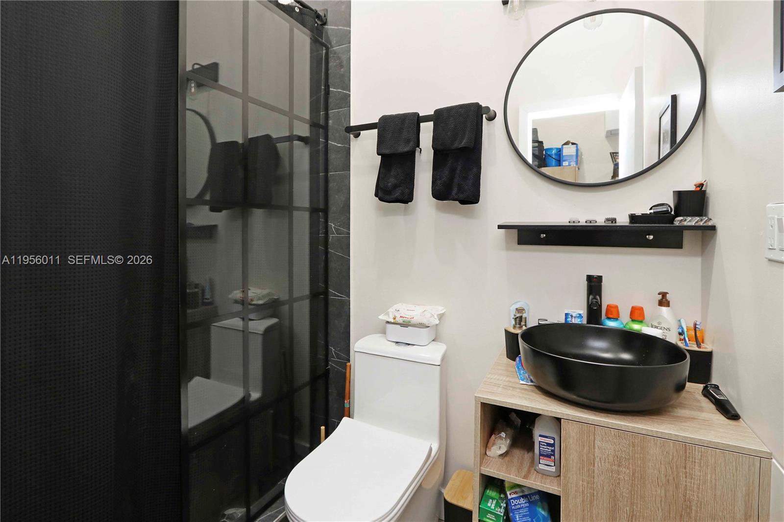 1345 Southwest 17th Street Miami, FL 33145 - Photo 13 of 21 a bathroom with a toilet a sink and a mirror