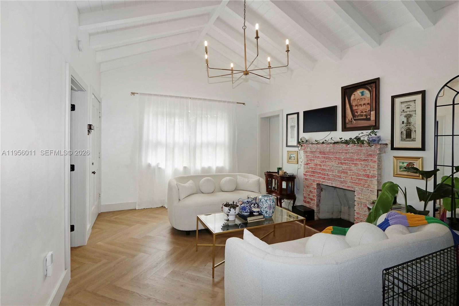 1345 Southwest 17th Street Miami, FL 33145 - Photo 3 of 21 a living room with furniture a fireplace and a flat screen tv