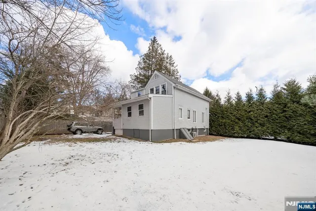 a view of a house with snow on the road