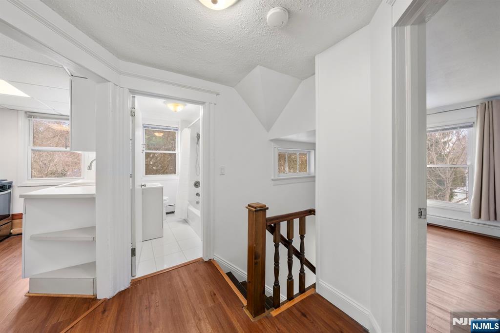 20 Columbus Avenue, Unit 2 Closter, NJ 07624 - Photo 3 of 15 a view of a hallway with wooden floor and stairs