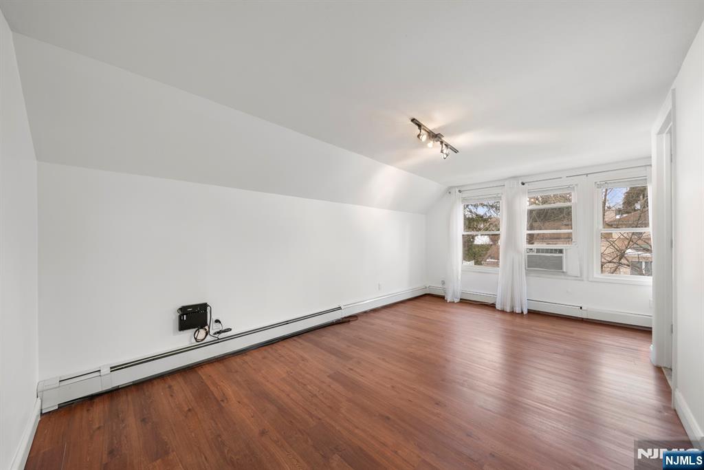 20 Columbus Avenue, Unit 2 Closter, NJ 07624 - Photo 6 of 15 an empty room with wooden floor and windows