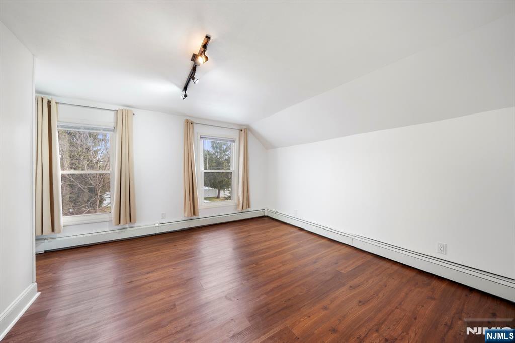 20 Columbus Avenue, Unit 2 Closter, NJ 07624 - Photo 10 of 15 a view of an empty room with wooden floor and a window