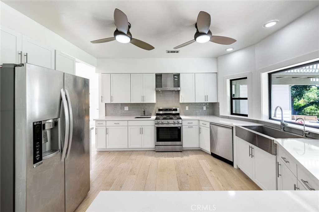 15601 Saddleback Road Canyon Country, CA 91387 - Photo 9 of 55 a kitchen with a refrigerator a sink and cabinets