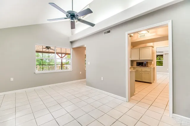 an empty room with fan and entrance