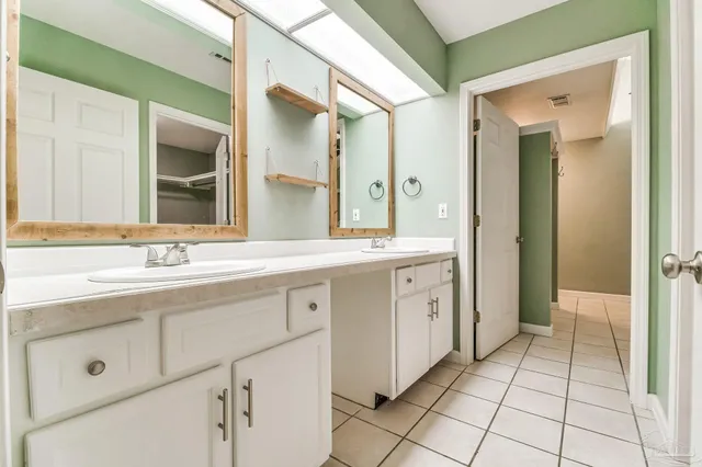 an empty room with a window and kitchen