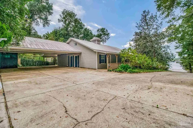 a view of house with wooden deck and wooden floor