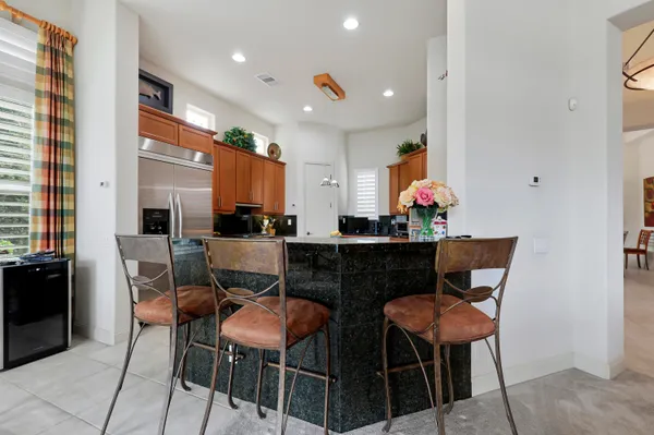 a kitchen with stainless steel appliances granite countertop white cabinets and white appliances
