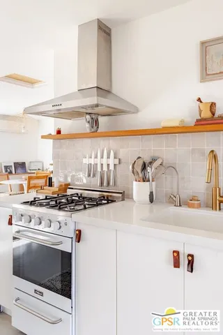 a table with a stove and a vase of it