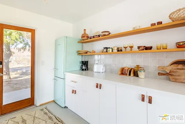 a view of a house with swimming pool and sitting area