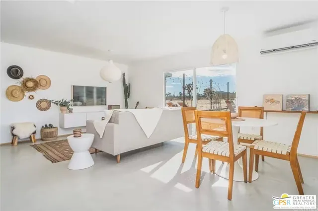 a view of a living room with furniture and a floor to ceiling window