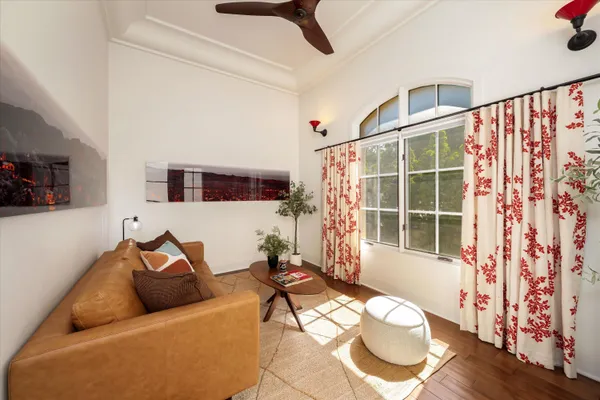 a living room with furniture and a floor to ceiling window