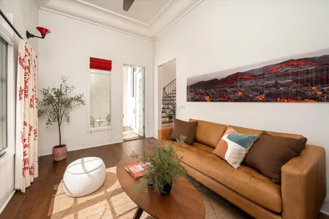 a living room with furniture and a floor to ceiling window