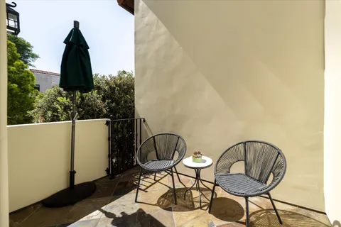 a view of a chair and table in the balcony